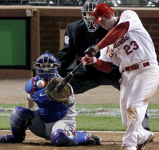 In this Oct. 27, 2011 file photo, St. Louis Cardinals' David Freese hits a solo home run off a pitch by Texas Rangers' Mark Lowe in the 11th inning of Game 6 of baseball's World Series , in St. Louis. The Cardinals have traded former World Series MVP Freese to the Los Angeles Angels in a four-player deal. The Cardinals also sent reliever Fernando Salas to the Angels on Friday, Nov. 22, 2013, in exchange for outfielder Peter Bourjos and prospect Randal Grichuk. 