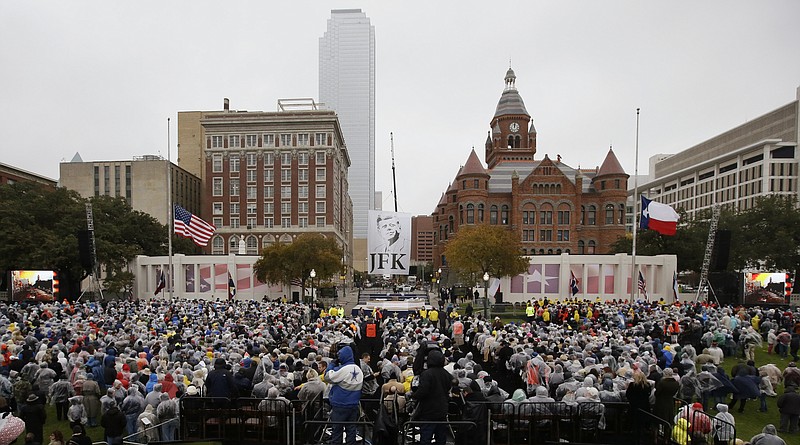 People gather before a ceremony Friday to mark the 50th anniversary of the assassination of John F. Kennedy, at Dealey Plaza in Dallas. President Kennedy's motorcade was passing through Dealey Plaza when shots rang out on Nov. 22, 1963.