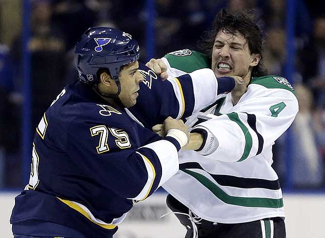 St. Louis Blues' Ryan Reaves, left, and Dallas Stars' Brenden Dillon fight during the first period of an NHL hockey game Saturday, Nov. 23, 2013, in St. Louis. 