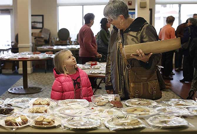 
Linley Pleus, 5, picks out cookie plates with her grandmother Carol Pleus at the annual cookie and craft sale Saturday morning at Heisinger Bluffs. Pleus has been taking her granddaughter for three years after taking her own kids and neices before that.
