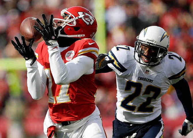 Kansas City Chiefs wide receiver Donnie Avery (17) catches a pass while covered by San Diego Chargers cornerback Derek Cox (22) during the first half of an NFL football game at Arrowhead Stadium in Kansas City, Mo., Sunday, Nov. 24, 2013.