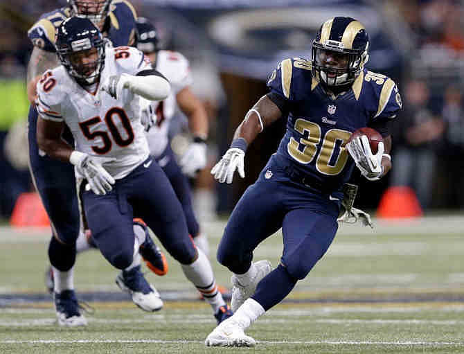 St. Louis Rams running back Zac Stacy, right, runs for a 35-yard gain as Chicago Bears linebacker James Anderson (50) pursues during the first quarter of an NFL football game on Sunday, Nov. 24, 2013, in St. Louis. 