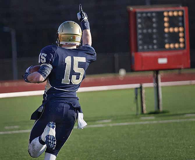 Helias running back Garret Buschjost (15) scores the game-clinching touchdown midway through the fourth quarter of Saturday's Class 4 semifinal game with Liberty North at Adkins Stadium.