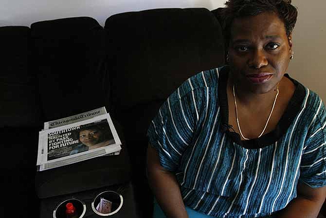 Rosa Pickett sits with a local newspaper story at her side in her home in Robbins, Illinois, on Thursday, Sept. 26, 2013. Pickett says she was raped more than 35 years ago and that police in her hometown took photos and collected rape kit samples. Now investigators at the Cook County Sheriff's department say there is no sign of the kit or the photos. They say Robbins police lost kits and they also found nearly 200 kits in a police evidence room were never tested or, if they were, were never investigated. 