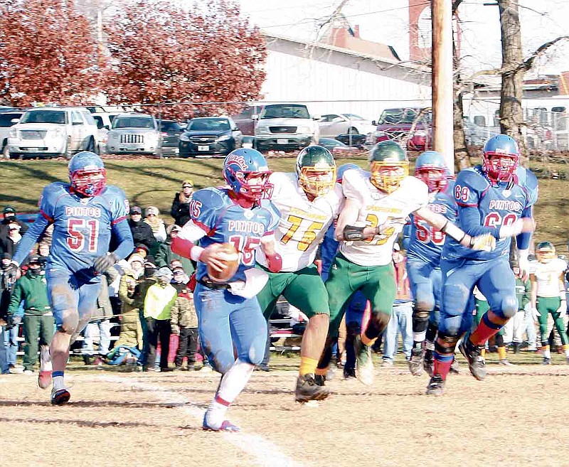 Democrat photo / April Arnett
California quarterback Jaden Barr gains ground with Maryville's Jacob Cacek (76) and Adam Thompson (33) on his trail during second quarter action at the Class 3 semifinal game Saturday at Riley Field. At left is California's Nathan Squires (51), and at right is Nathan Goans (56) and Alexx Lewis (69).