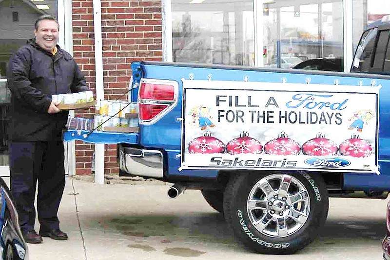 Democrat photo / David A. Wilson
Gary Hamilton of Sakelaris Ford of California with some of the food destined for a food pantry after donation to the "Fill a Ford for the Holidays."  