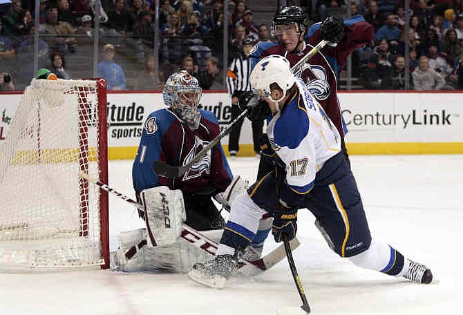 St. Louis Blues center Vladimir Sobotka (17) drives to the net against Colorado Avalanche defenseman Tyson Barrie (4) and Avalanche goalie Semyon Varlamov (1) during the second period of an NHL hockey game in Denver, Wednesday, Nov. 27, 2013. 