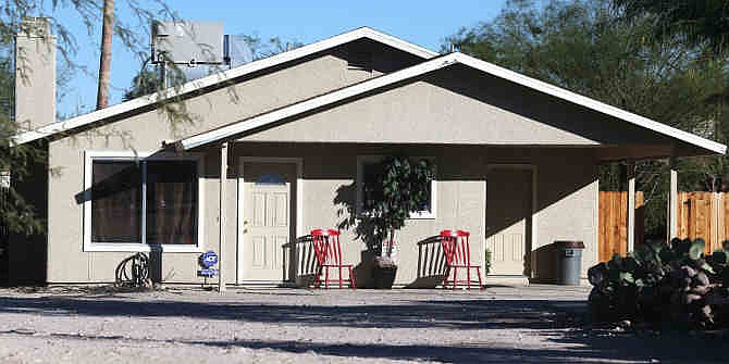 This Tuesday, Nov. 26, 2013 photo shows the home where three girls were allegedly imprisoned by their mother and stepfather, in Tucson, Ariz. Tucson Police Capt. Michael Gillooly said Tuesday at a news conference that all three girls were malnourished and dirty, and they told officers they hadn't taken a bath in up to six months. The couple made their initial court appearances Wednesday. (AP Photo/Arizona Daily Star, Mike Christy)