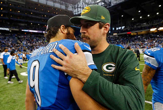 Detroit Lions quarterback Matthew Stafford (9) hugs Green Bay Packers quarterback Aaron Rodgers after an NFL football game at Ford Field in Detroit, Thursday, Nov. 28, 2013. The Lions won 40-10. 