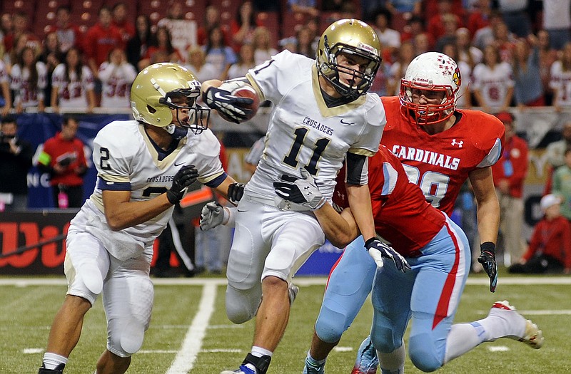Helias' Trent Dudenhoeffer tries to break free from Webb City's Austin Carter while returning a fourth-quarter kickoff during Friday's MSHSAA Show-Me Bowl Class 4 final at the Edward Jones Dome in St. Louis.