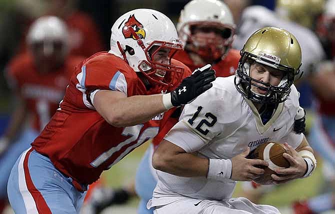 Helias quarterback Wyatt Porter, right, is sacked for a loss by Webb City defensive end Brain Arterburn during the first half of the Missouri Class 4 state high school football championship Friday, Nov. 29, 2013, in St. Louis. 