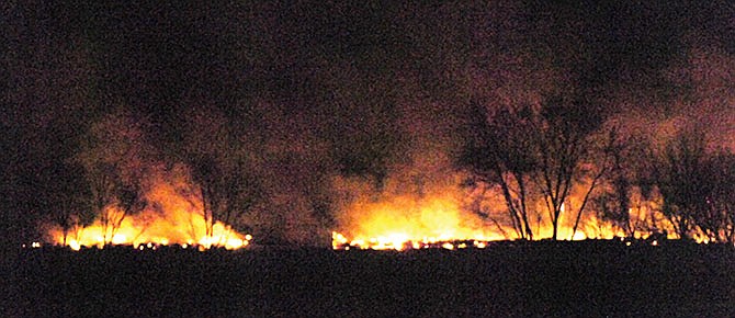 A fire burns Friday Nov. 29, 2013 from a 30-inch natural gas pipeline that ruptured in a rural area near Hughesville, Mo. Authorities said the pipeline, owned by Panhandle Eastern Pipeline Co., ruptured shortly before midnight Thursday. No injuries were reported and the pipeline has been shut down so crews can repair the line. (AP Photo/The Sedalia Democrat, Dennis Rich)