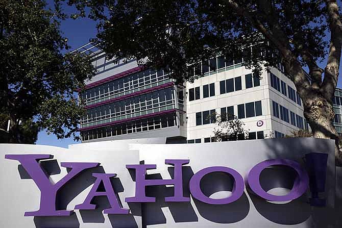 In this Wednesday, Oct. 17, 2012, photo, shows a sign in front of Yahoo! headquarters in Sunnyvale, Calif. Yahoo said Monday, Nov. 18, 2013, that it is expanding its efforts to protect its users' online activities from prying eyes by encrypting all the communications and other information flowing into the Internet company's data centers around the world.