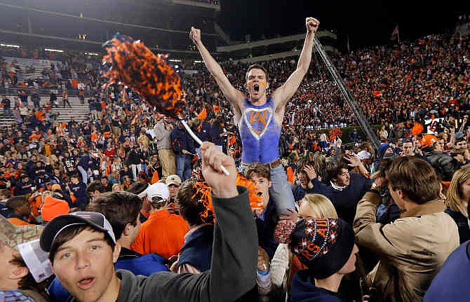 Auburn fans storm the field after their 34-28 after a win over top-ranked Alabama in an NCAA college football game in Auburn, Ala., Saturday, Nov. 30, 2013. 