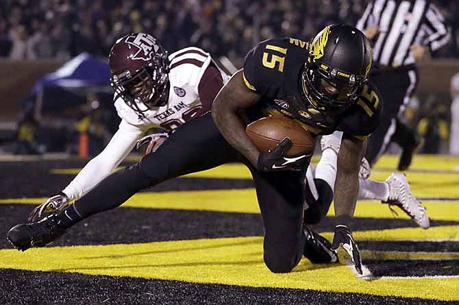 Missouri wide receiver Dorial Green-Beckham, front, falls in the end zone after catching a 38-yard touchdown pass as Texas A&M defensive back Deshazor Everett defends during the second quarter of an NCAA college football game on Saturday, Nov. 30, 2013, in Columbia, Mo.
