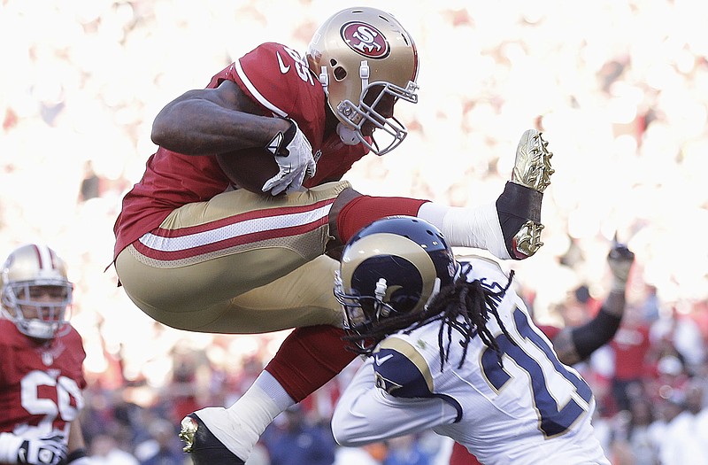 49ers tight end Vernon Davis jumps into the end zone over Rams cornerback Janoris Jenkins during the fourth  quarter Sunday in San Francisco.