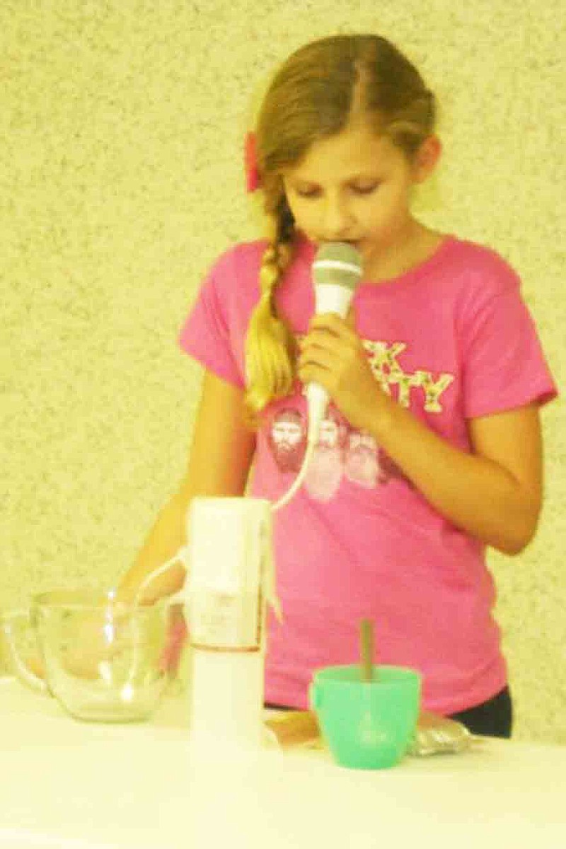 Photo submitted 
Ginna Meisenheimer, Jamestown 4-H Club, demonstrates how to make a Mexican Fiesta Dip to the club.