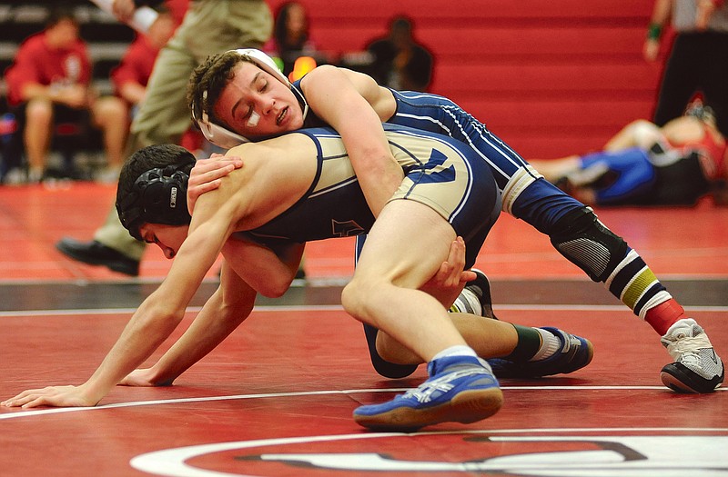Helias' Slater Schrimpf (top) takes on a Holt opponent during last year's Capital City Invitational. Schrimpf returns this season at one of the lower weights for the Crusaders.