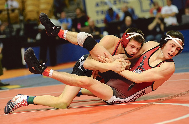 Jefferson City's Logan Moriarity (left) takes down William Erneste of Park Hill during the 120-pound third-place match in last year's Class 4 state tournament.