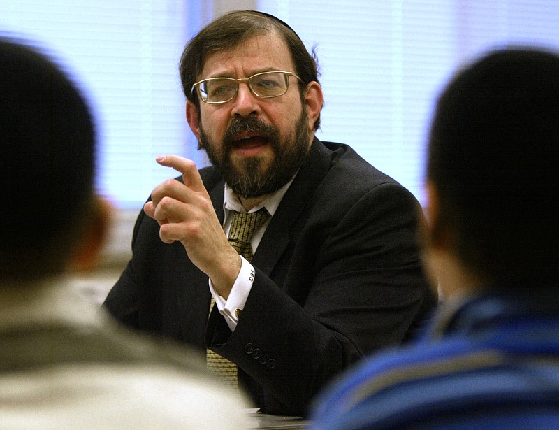 Rabbi S. Binyomin Ginsberg leads students in January 2003 at the Torah Academy in St. Louis Park, Minn., in a discussion and debate. The Supreme Court indicated Tuesday that it won't offer much help to frequent flyers who want to sue when airlines revoke their miles or their memberships.