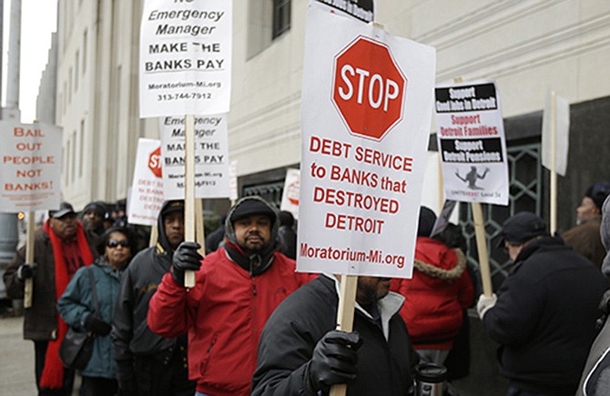 Detroit city workers and supporters protest Tuesday outside the federal courthouse in Detroit while awaiting the bankruptcy decision.