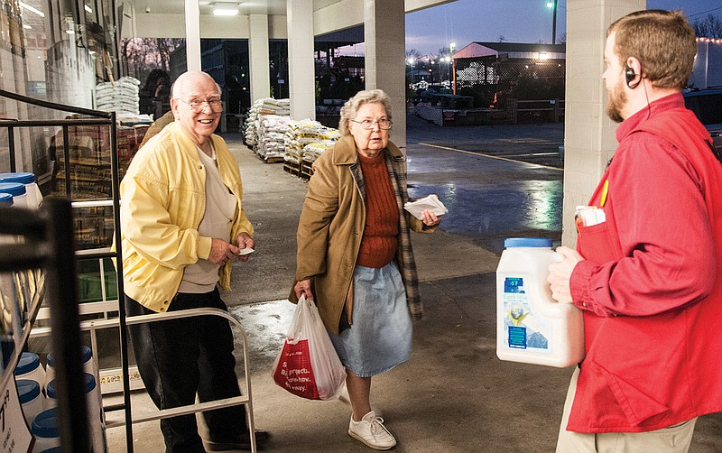 Scott Sebacher, assistant manager at Westlake Hardware in Fulton, greets Paul and Lena Gallatin outside the store to carry their ice melt to their cars. The couple bought the ice melt in preparation for the snow storm coming on Thursday and future winter weather.