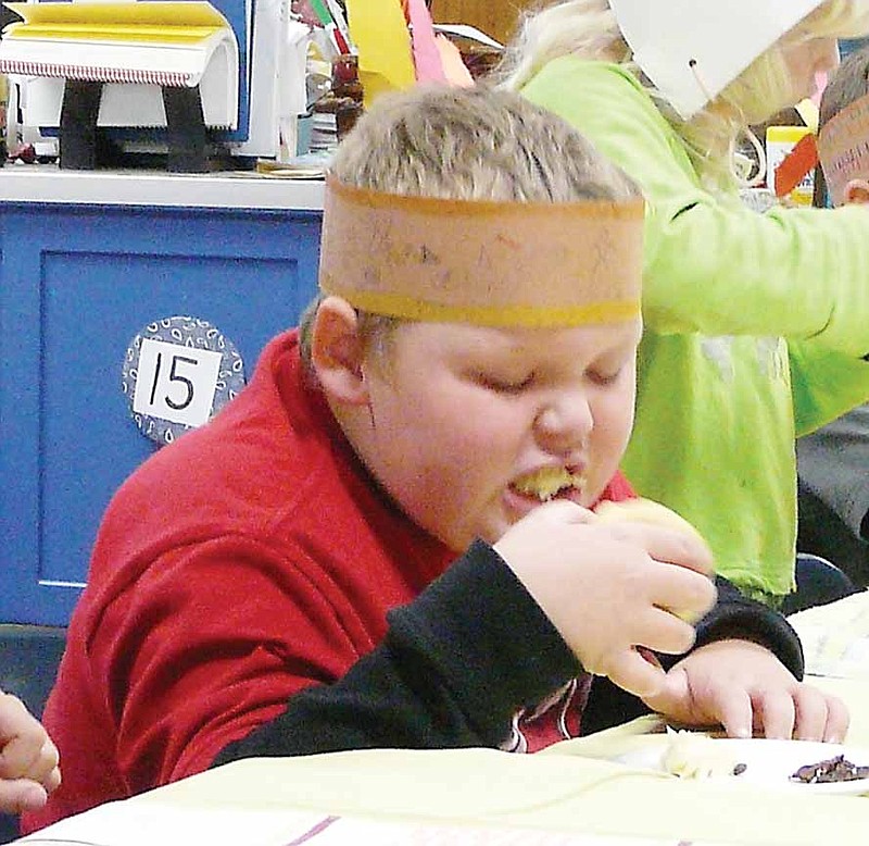 High Point second grader, Jack Besche, enjoys his biscuit and butter at the end of the feast Tuesday, Nov. 26.
