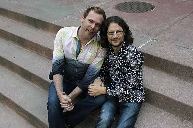 This June 6, 2013 file photo shows Dave Mullins, right, sitting for a portrait with his husband Charlie Craig, in Denver. The gay couple successfully pursued a discrimination complaint against a Colorado bakery, saying the business refused them a wedding cake for a family reception in Colorado after they were married in a Massachusetts ceremony. 