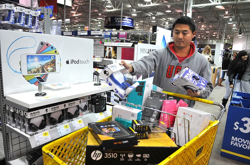 Steven Doan picks up a few gifts while shopping at Best Buy in Savannah, Ga., on Friday Nov. 29, 2013.