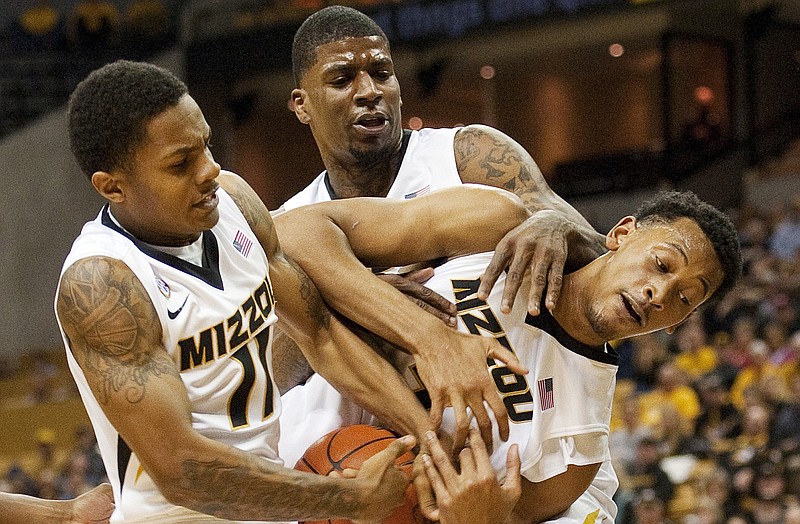 Missouri players (from left) Shane Rector, Tony Criswell and Johnathan Williams III fight each other for a rebound during the first half of Thursday's game with West Virginia in Columbia.
