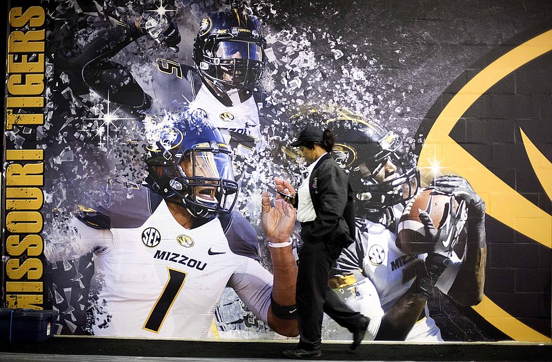 A security guard walks past the Missouri locker room Friday at the Georgia Dome in Atlanta. The Tigers will play Auburn today in the Southeastern Conference championship game.