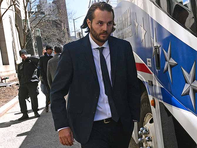 In this April 3, 2013 file photo, former Goldman Sachs trader Matthew Taylor leaves Manhattan federal court in New York. Taylor was sentenced to nine months in prison for wire fraud on Friday, Dec. 6, 2013, by a Manhattan judge. Earlier in 2013, Taylor had plead guilty to concealing an unauthorized $8.3 billion trading position in 2007. He admitted his wrongdoing to Goldman within 36 hours, but escaped criminal charges until this year. 