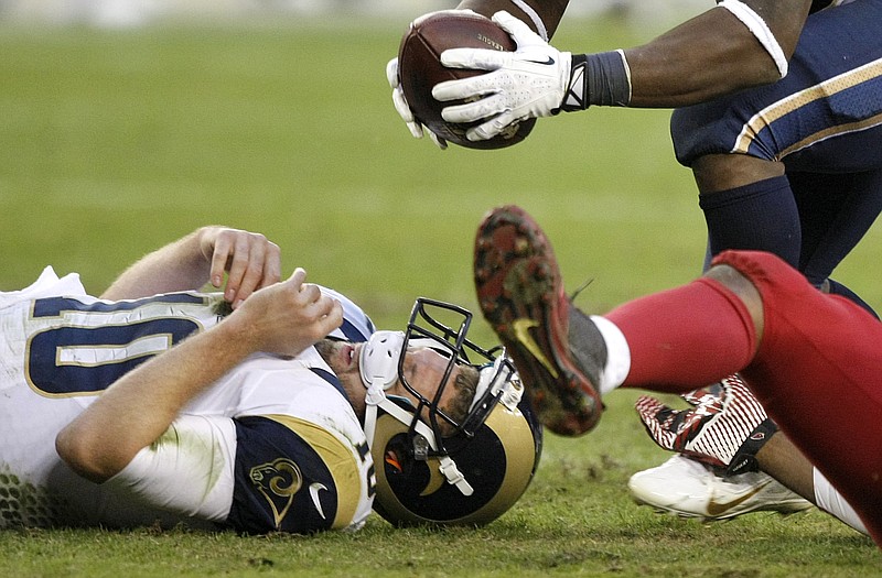 Rams quarterback Kellen Clemens hits the ground as his fumble is recovered by a teammate during the second half of Sunday's loss to the Cardinals in Glendale, Ariz.