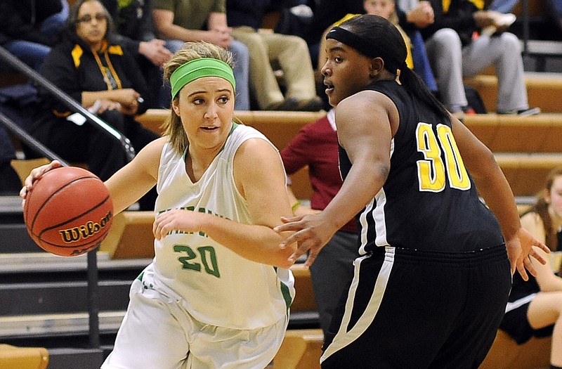 LeeAnn Polowy of Blair Oaks drives past NaShayla Brandt of Fulton during Monday night's game in Wardsville.