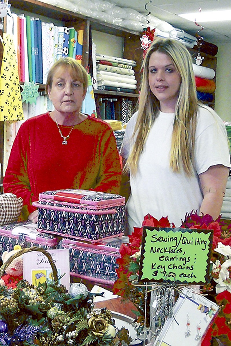 Pam Buda, left, and Elizabeth Buda, right, of Oak Street Fabrics and More pose with a variety of unique Christmas items in their store during Christmas California Style Open House, Friday, Dec. 6.