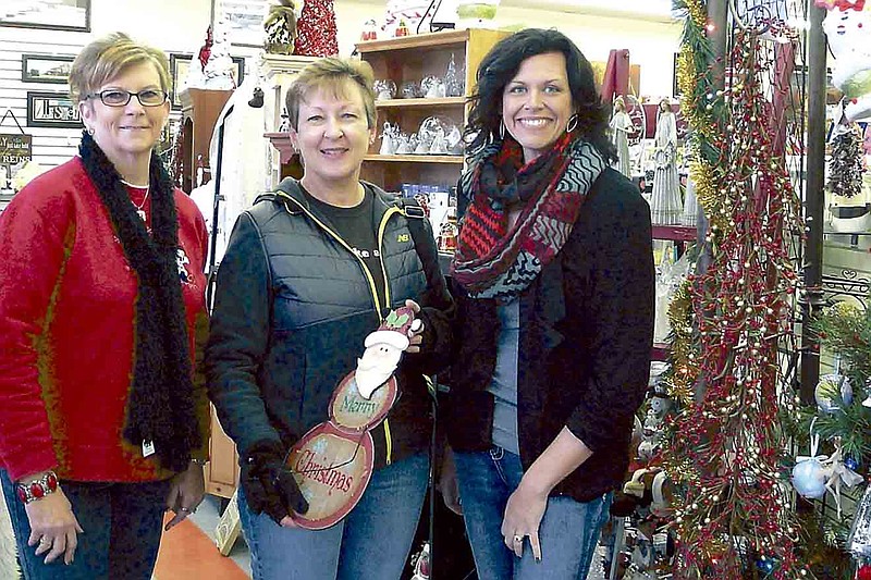 Bond Pharmacy staff assist Roberta Rothstein during a recent visit during their open house Friday, Dec. 6.  From left, Colene Volkart, Rothstein and Amanda Trimble.