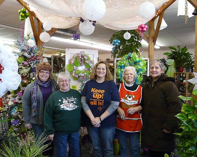 Workers and shoppers enjoy The Flower Shop Open House, Saturday, Dec. 7, at the Village Green Shopping Center. From left to right, Tammy Bleich, Barb Walters, Robin Ratcliff, Sharon Hammen and Beulah Ziegs.