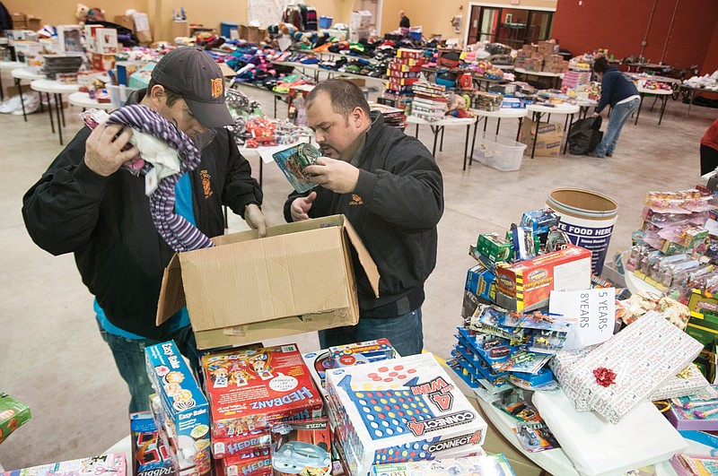 (From left to right) Michael Bainbridge, Fulton firefighter and secretary and treasurer of the Union of Fulton Professional Firefighters, and Merit McLeod, Fulton firefighter and president of the union, sort through the fire department's donation of toys at Westminster College's Mueller Center on Tuesday. The firefighters collected about 150 toys to donate to SERVE, Inc.