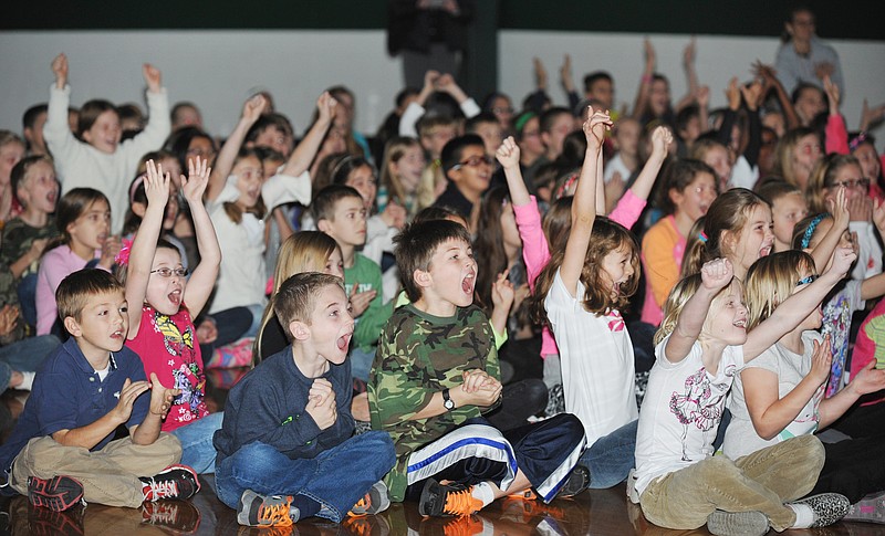 St. Joseph Cathedral School students react to seeing their school's name on the screen and finding out the school was just awarded $25,000. The Catholic elementary school was one of 20 winners across the country who ranked high enough in U.S. Cellular's "Calling All Communities' campaign.