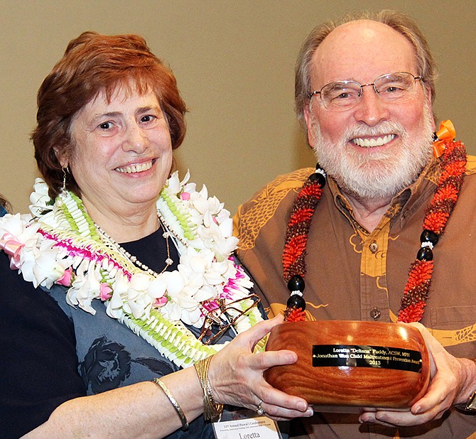Hawaii state Health Department Director Loretta Fuddy and Gov. Neil Abercrombie pose for a photo March 21. Fuddy was aboard a small plane carrying nine people that crashed into the ocean Wednesday off the Hawaiian island of Molokai, officials said. Fuddy died in the crash. The eight others onboard, including the pilot, survived.