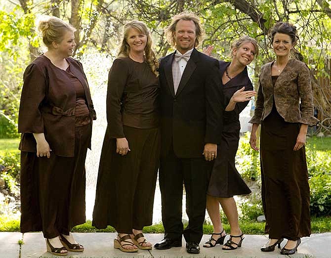 In this undated file photo provided by TLC, Kody Brown, center, poses with his wives, from left, Janelle, Christine, Meri, and Robyn in a promotional photo for TLC's reality TV show, "Sister Wives." Advocacy groups for polygamy and individual liberties on Saturday, Dec. 14, 2013, hailed a federal judge's ruling that key parts of Utah's polygamy laws are unconstitutional, saying it will remove the threat of arrest for those families. The ruling was a victory for Brown and his four wives and other fundamentalist Mormons who believe polygamy brings exaltation in heaven.