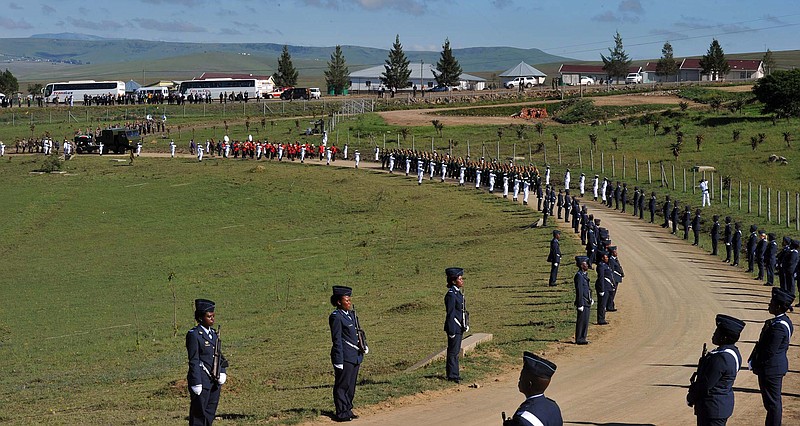 A military honor guard lines the route Sunday for former South African president Nelson Madela's funeral procession as it makes its way to his final resting place in his home village of Qunu, South Africa.