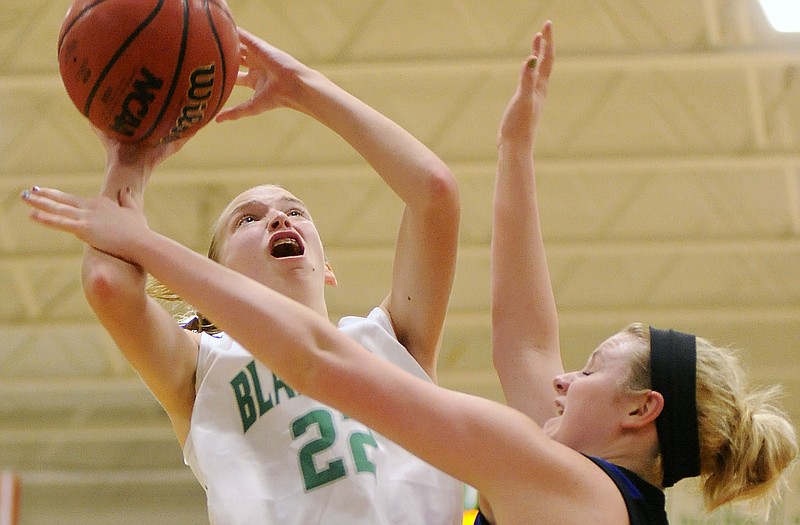 Blair Oaks' Chelsi Emerson puts up a shot against Russellville's Haley WIndsor on Monday night in Wardsville.