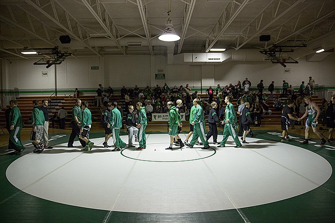 The Blair Oaks wrestling squad shakes hands with wrestlers from Warsaw after Tuesday night's dual match at the Blair Oaks gym.