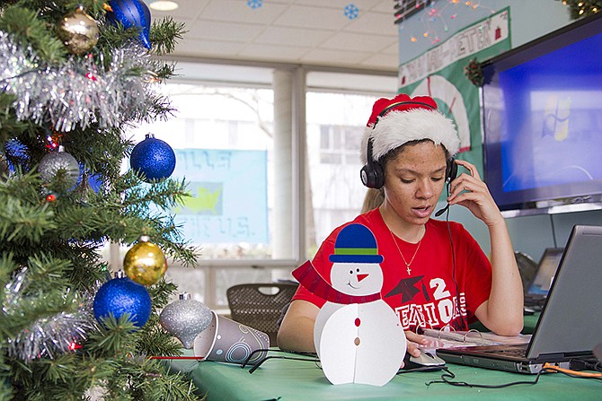 University of Illinois student Katherine Moss sings to callers as part of the annual Dial-A-Carol program in Champaign, Ill. The student-run project is a hotline of sorts for people who prefer their holiday carols sung live by amateurs. The program was started in 1960 by a former hall secretary, Betty Gordon, and a group of the dorm residents. Last year, the student volunteers took more than 4,000 calls from people all over the world requesting Jingle Bells, White Christmas and Rudolph the Red-Nosed Reindeer.