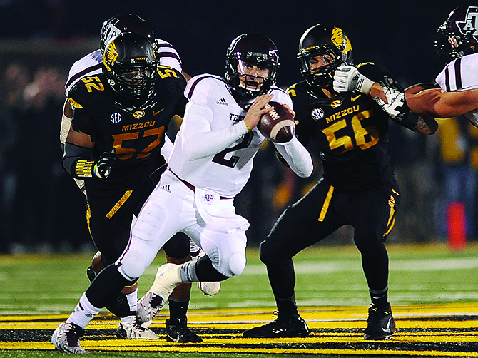 Missouri defensive end Michael Sam (left) puts pressure on Texas A&M quarterback Johnny Manziel during a game last month at Faurot Field. Sam was named a first-team All-American on Tuesday by the Associated Press.