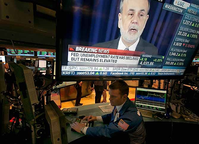 The news conference of Federal Reserve Chairman Ben Bernanke appears on a television screen at a trading post on the floor of the New York Stock Exchange, Wednesday, Dec. 18, 2013. The Federal Reserve has decided to reduce its stimulus for the U.S. economy because the job market has shown steady improvement. The Fed will trim its $85 billion a month in bond purchases by $10 billion starting in January.