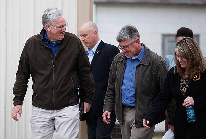 Gov. Jay Nixon, left, talks with Richard Fordyce, center, before a Thursday news conference at the Lanny Frakes farm in Rushville. Nixon later announced Fordyce as the new director of the Missouri Department of Agriculture. 