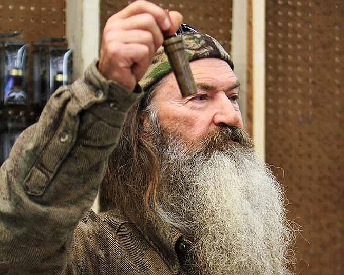 This Nov. 7, 2013 file photo shows Phil Robertson, the Duck Commander, holding the 1 millionth duck call assembled for 2013 at company's warehouse in West Monroe, La. 