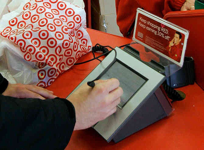 In this Jan. 18, 2008 file photo, a customer signs his credit card receipt at a Target store in Tallahassee, Fla.